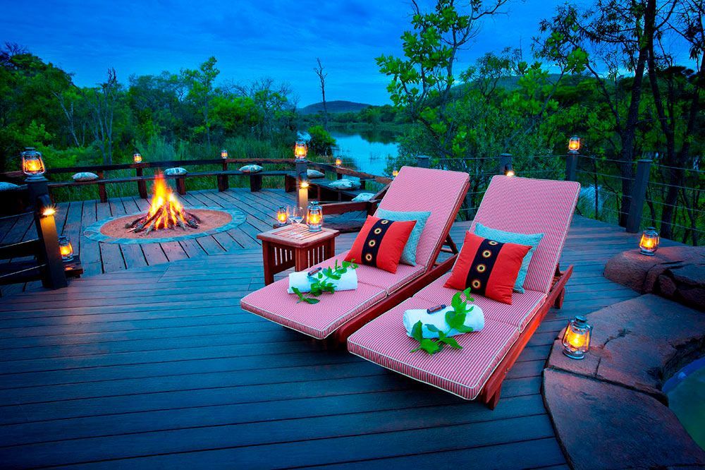Hippo Lakes Luxury African Safari Lodge luxury safari tent firepit and lounge chairs on the deck